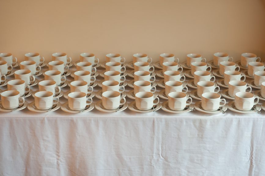 many cups and saucers arranged uniformly
