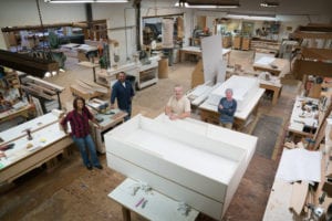 Elevated portrait of a proud team of carpenters in a cabinet shop